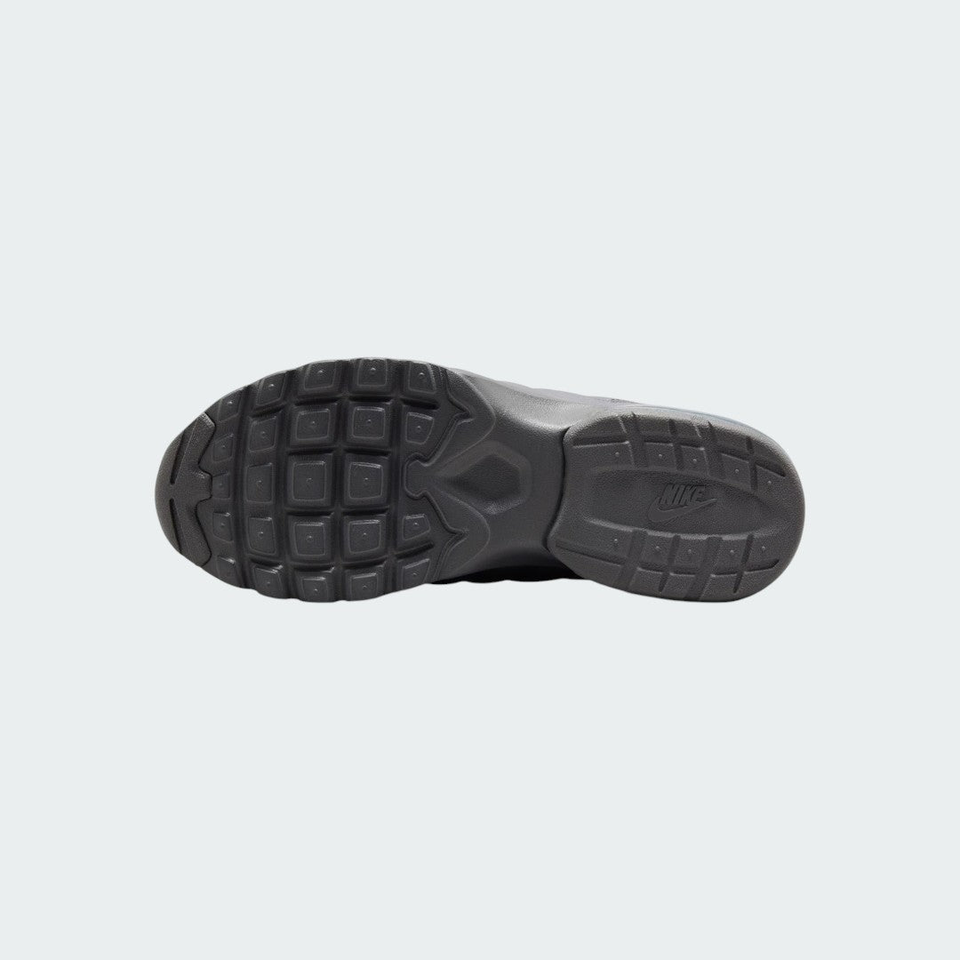 View of the outsole of the Nike Air Max Invigor Print Girls' black trainers, showing the durable rubber tread pattern.