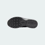 View of the outsole of the Nike Air Max Invigor Print Girls' black trainers, showing the durable rubber tread pattern.