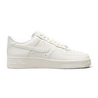 Displays the full lateral silhouette featuring the soft Pink Oxford mesh upper, the striking layered metallic Swoosh design, the thick white React foam midsole with embedded Air Zoom branding, and the textured outsole edge