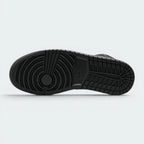 Displays the classic hoops traction blueprint of the solid rubber outsole, showcasing the circular forefoot pivot point and geometric heel blocks engineered for unreal multi-surface traction.