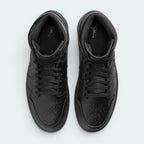 Focuses on the locked-in traditional lacing layout, displaying the perfect symmetry of the matte black cotton laces, the tonal textile tongue, and the iconic starburst perforation pattern tracking down the front leather toe box area.