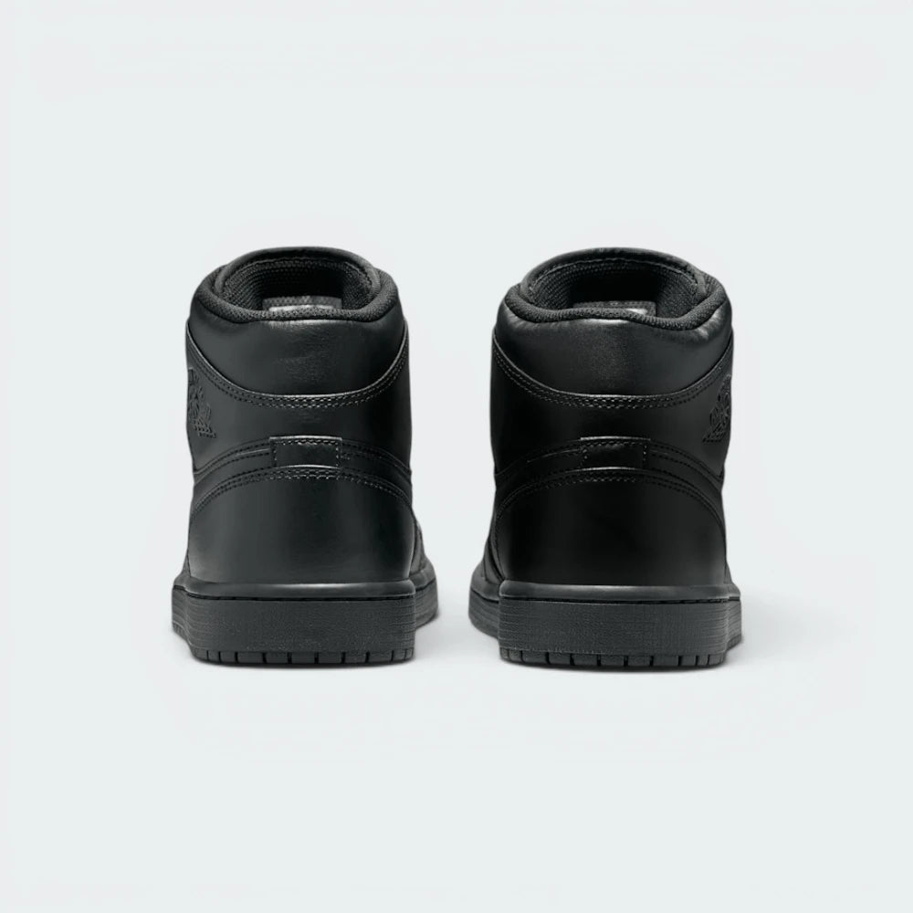 Focuses on the contoured shape of the padded ankle collar, highlighting the seamless leather heel cup and the clean, uniform stitching rows tracking cleanly above the dark rubber sole line.