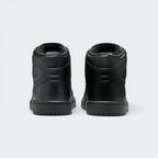 Focuses on the contoured shape of the padded ankle collar, highlighting the seamless leather heel cup and the clean, uniform stitching rows tracking cleanly above the dark rubber sole line.