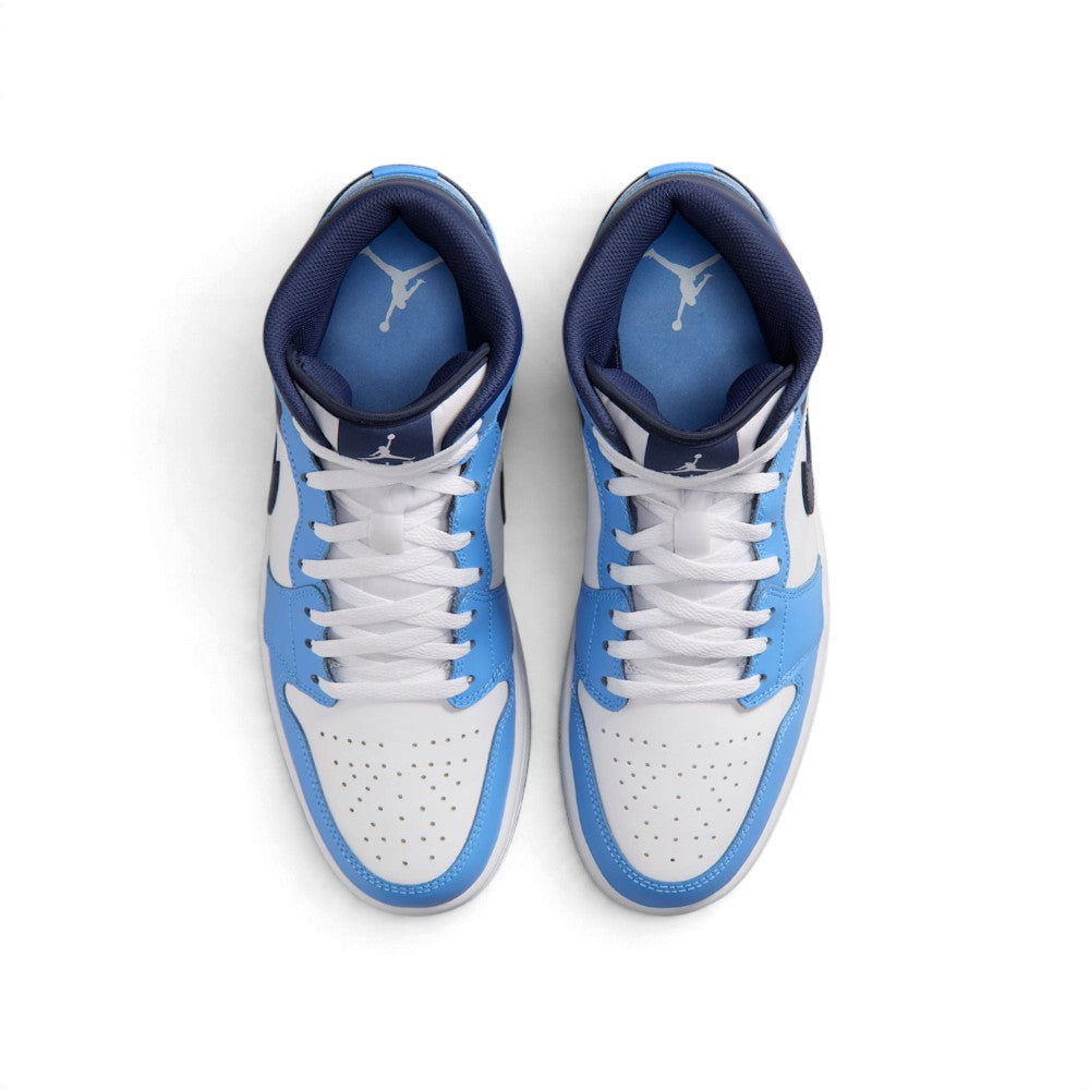 Overhead view of both mid-top sneakers showing the central lacing system, perforated toe boxes, and insoles printed with Jumpman branding.