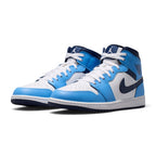 Three-quarter forward angle showcasing both sneakers side by side, highlighting their mid-top silhouette and bold blue-and-navy colour blocking.