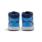 Rear view of the sneakers emphasizing the heel overlays, stitched pull tabs, and the textured rubber sole wrap.
