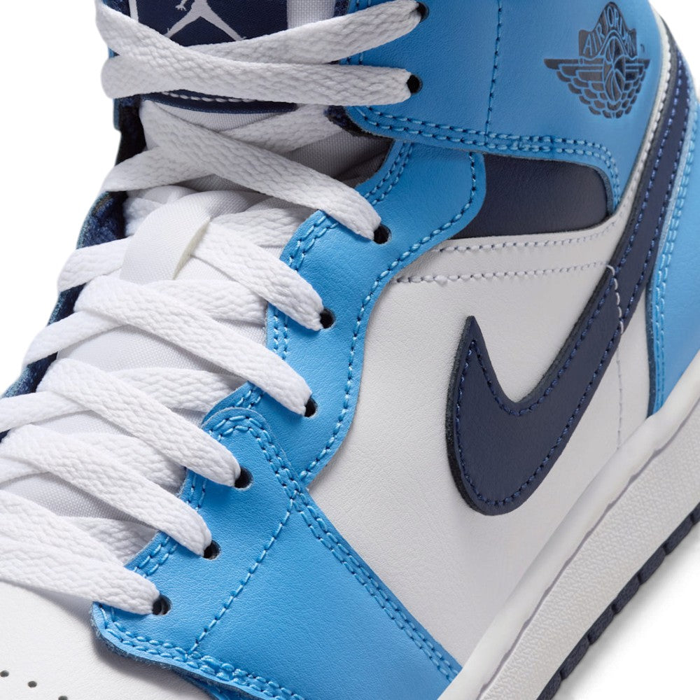 Macro focus on the forefoot and eyestay, detailing the fine leather grain, flat white laces, and reinforced stitching lines.