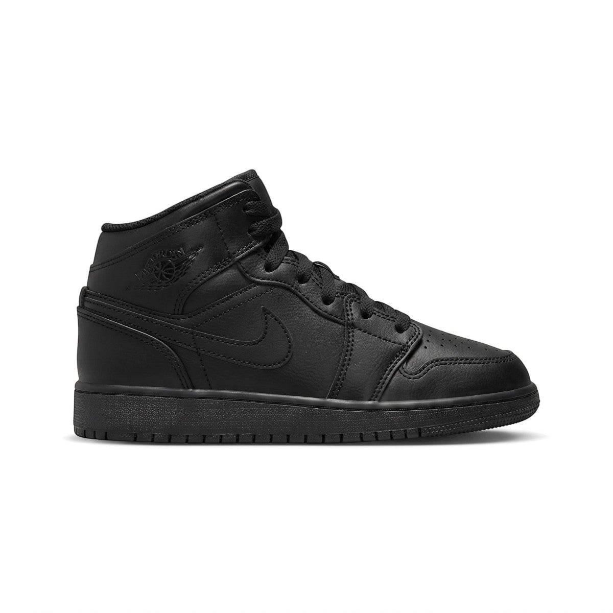 Side profile of the Air Jordan 1 Mid Junior Trainer in Triple Black showing smooth leather upper, mid-top collar, embossed Wings logo, and solid black rubber sole.
