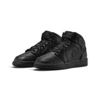 Three-quarter forward angle showcasing both sneakers side by side, highlighting their iconic mid-top silhouette and all-black colour blocking.