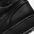 Close-up of the lateral collar panel, highlighting the embossed Air Jordan Wings logo, premium leather grain, and reinforced stitching.