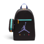 Highlights the black polyester backpack with the attached matching pencil case clipped to the side, showing the prominent purple Jumpman logo, multi-coloured "AIR" lettering, bright teal front zip track with a yellow pull tab, and purple top grab loop.