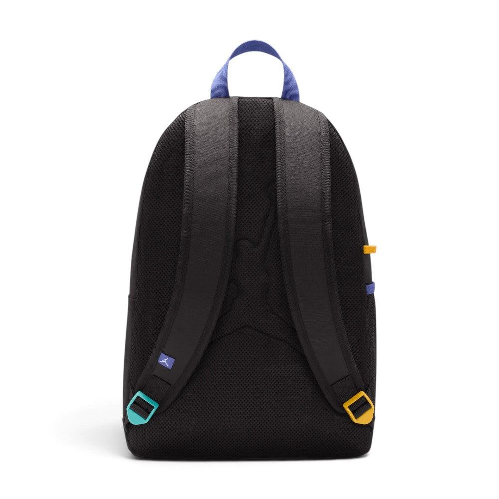 Shows the padded black mesh back panel and matching padded shoulder straps, highlighting the blue woven Jumpman tag, contrasting teal and yellow strap adjustment buckles, and the purple top webbing loop.