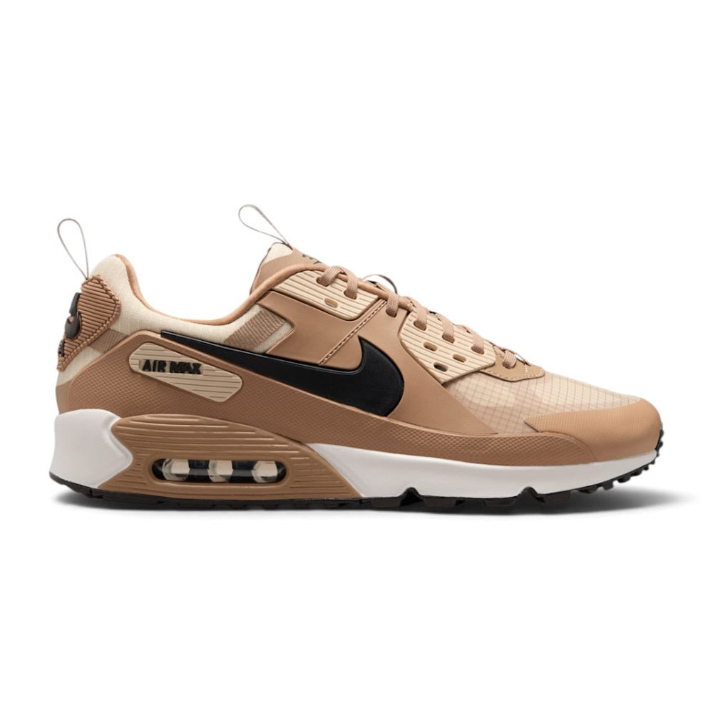 Highlights the rugged lateral profile showing the Parachute Beige ripstop base, Light Khaki synthetic leather overlays, heavy-duty black rubber mudguard, tactical sidewall webbing, and the visible Max Air window set into a Summit White foam midsole carrier.