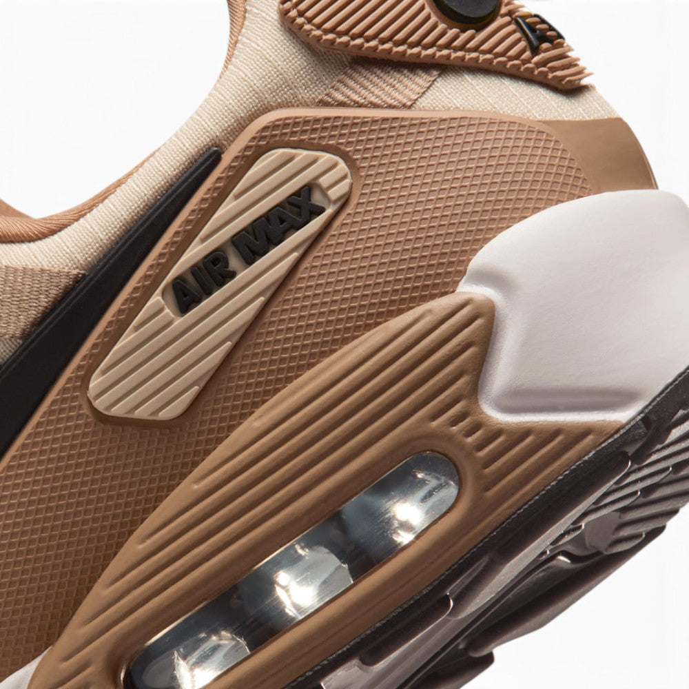 Highlights the "unreal" clean finish where the Summit White foam midsole meets the visible heel Max Air cassette, framed by the grooved black rubber Waffle outsole tread.