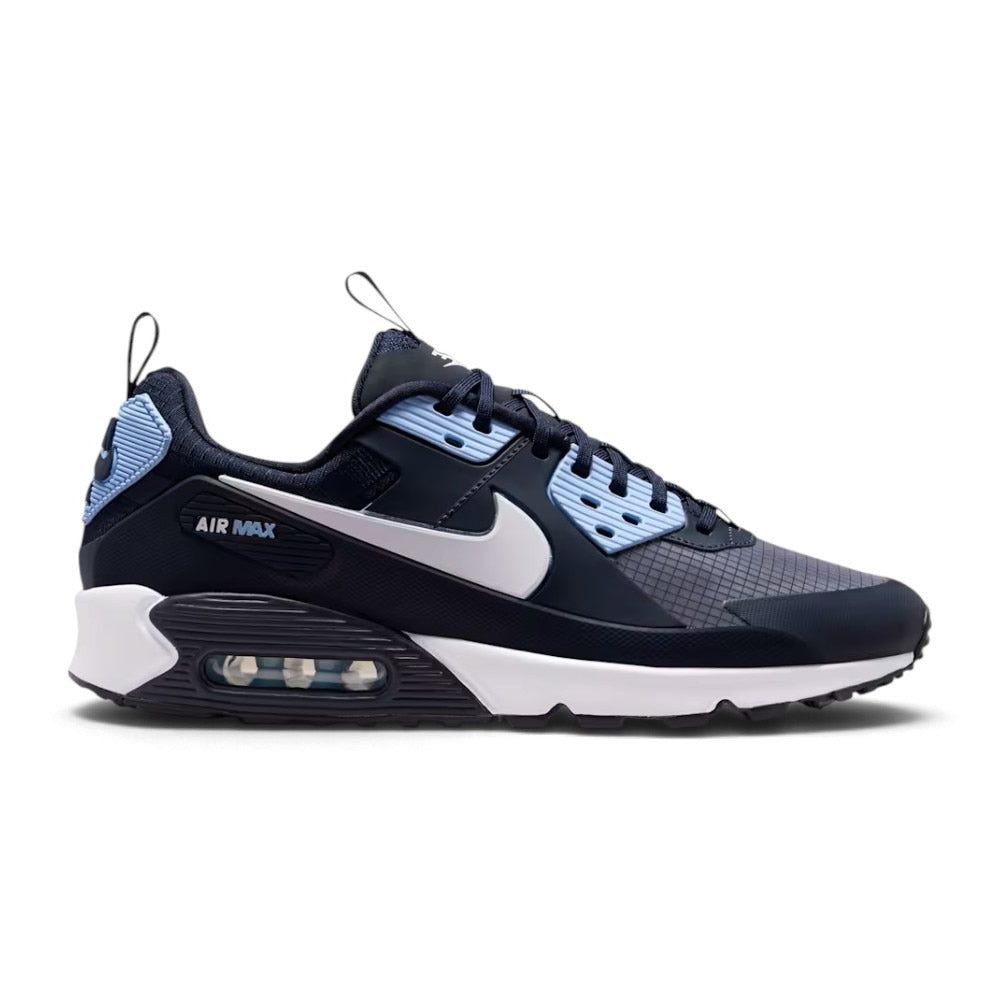 Side profile of the Nike Air Max 90 Drift Men's Trainer in Dark Obsidian, Psychic Blue, and White showing ripstop upper, rubber and synthetic leather overlays, and Max Air unit.