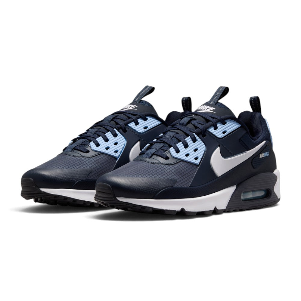Three-quarter forward angle showcasing both sneakers side by side, highlighting their multi-layered hybrid aesthetic and navy-and-blue color blocking.
