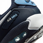 Close-up of a Nike Air Max sneaker showing the midsole, heel, and upper in navy blue, black, and light blue.