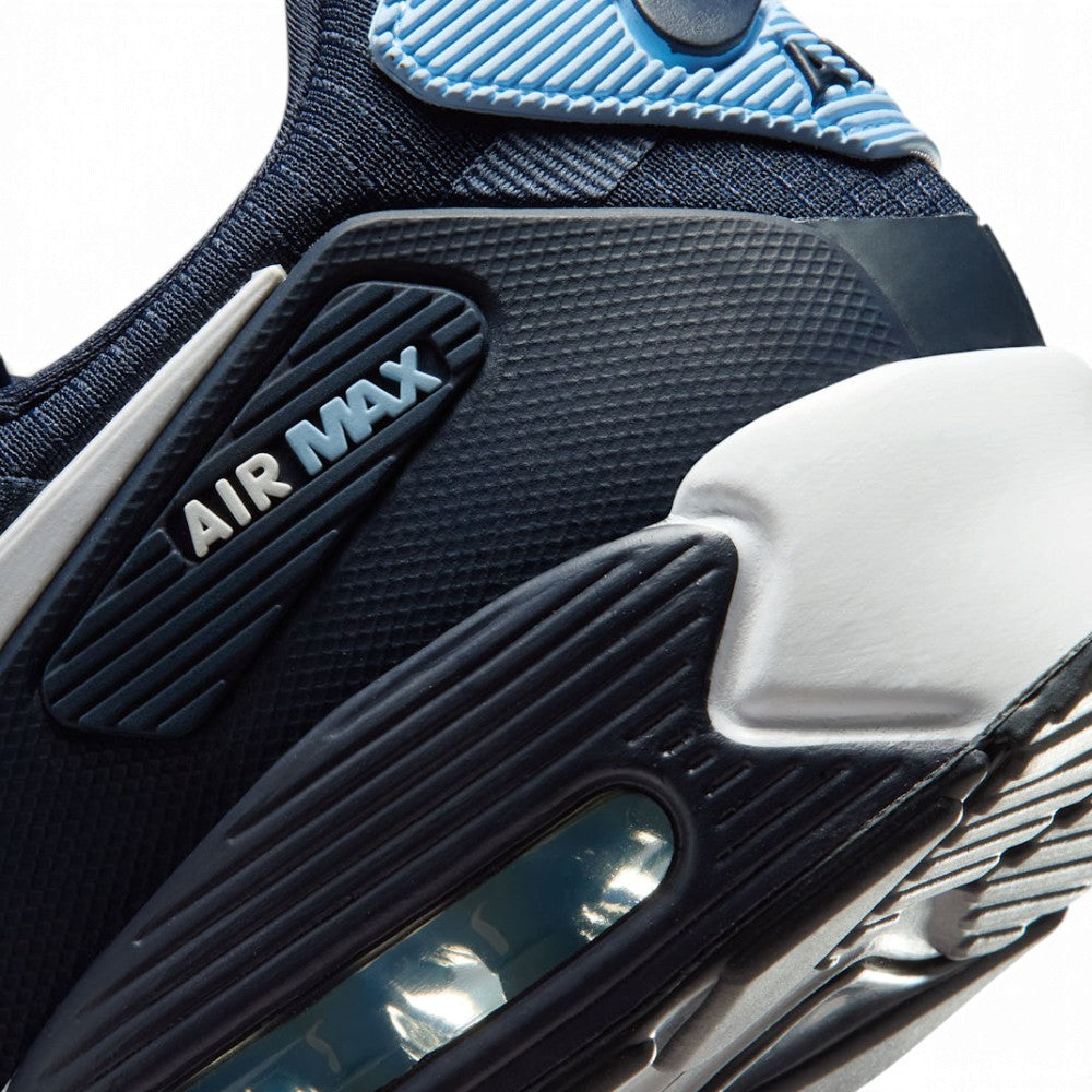 Close-up of a Nike Air Max sneaker showing the midsole, heel, and upper in navy blue, black, and light blue.