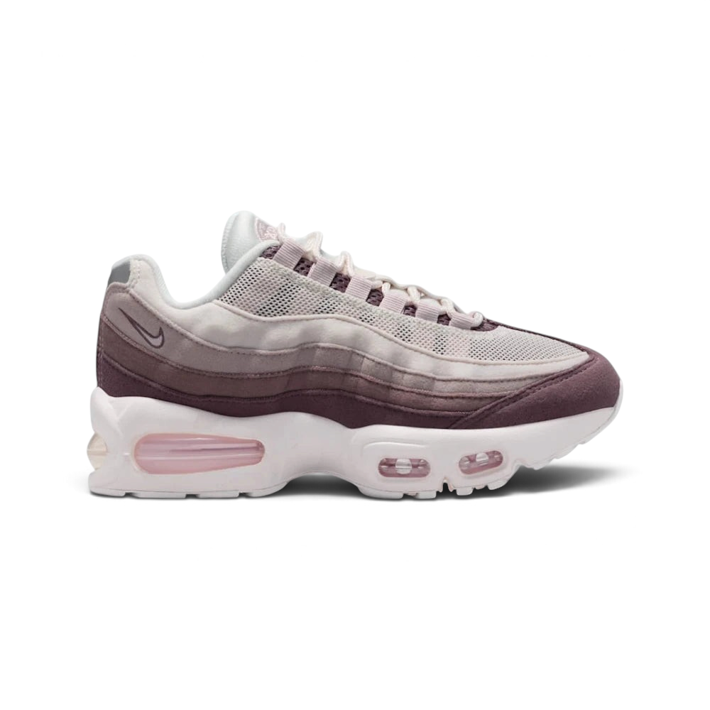 Highlights the high-velocity sweep of the gradient side stripes, showing how the Phantom upper mesh shifts smoothly into Silt Red and Tattoo grey leather muscle panels resting above the chunky white midsole with visible windows. Main image