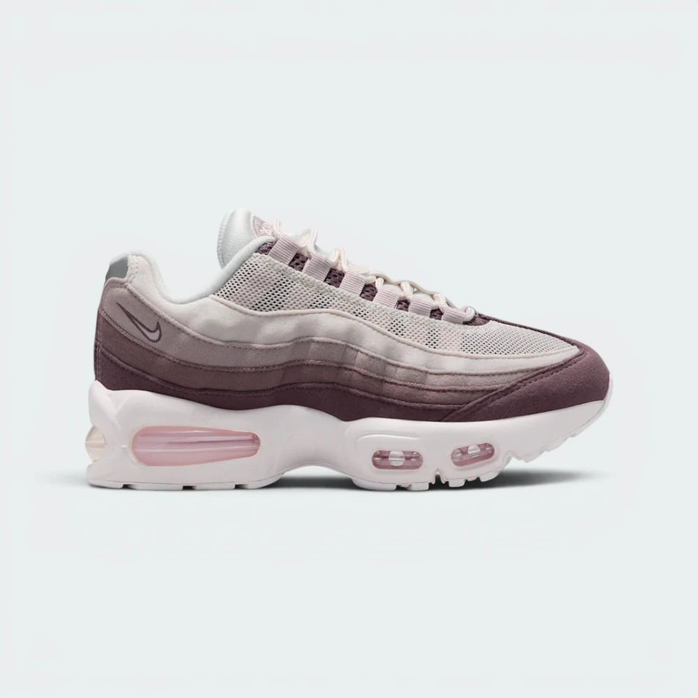 Highlights the high-velocity sweep of the gradient side stripes, showing how the Phantom upper mesh shifts smoothly into Silt Red and Tattoo grey leather muscle panels resting above the chunky white midsole with visible windows. Main image