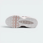 Displays the spine-inspired geometric tread pattern of the black rubber sole, showcasing the deep flex grooves engineered for unreal everyday walking flexibility.