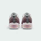 Focuses on the contoured shape of the low-cut ankle collar, highlighting the reflective heel panel detailing and the vertical spine-inspired structural lines running down the rear.