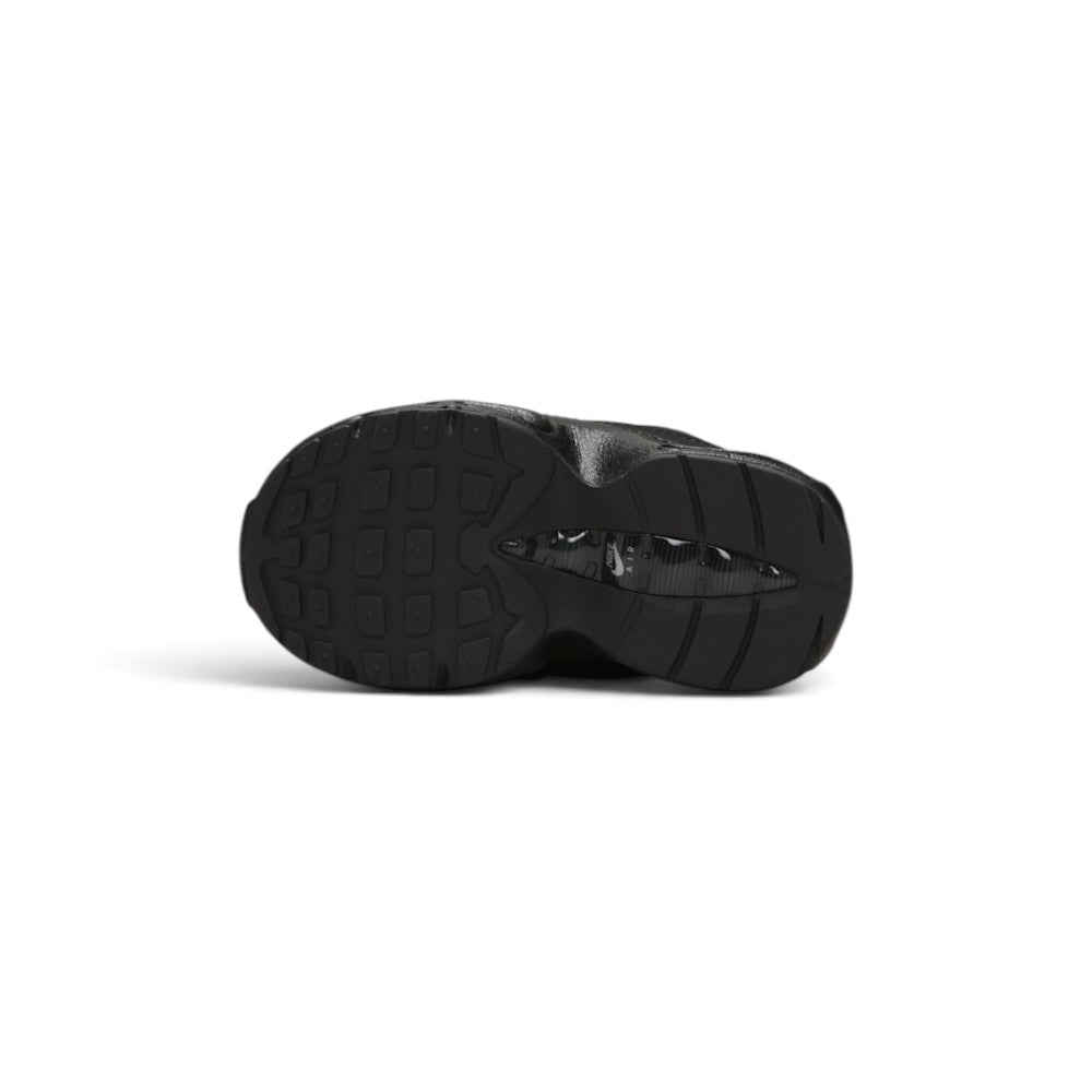 Displays the full-length black rubber outsole, showcasing the deep anatomical flex grooves, waffle perimeter grip lugs, and central spine shank inset featuring a white Nike Air logo.