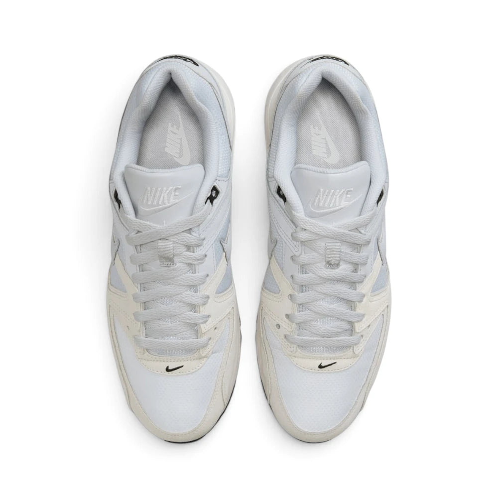 Focuses on the locked-in central lacing layout, displaying the light grey mesh tongues, matching laces, off-white suede eyestay overlays, mini black Swoosh on the toe guard, and light grey insoles with white Nike branding.