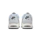 Focuses on the rear profile, highlighting the grey leather heel panels printed with black "NIKE AIR" logos and the wide stack of the cream foam midsole base enclosing the Air unit.