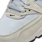 Details the micro-precision of the forefoot area, showing the textured off-white suede mudguard, double-stitched seams, light grey laces, and embroidered mini black Swoosh.