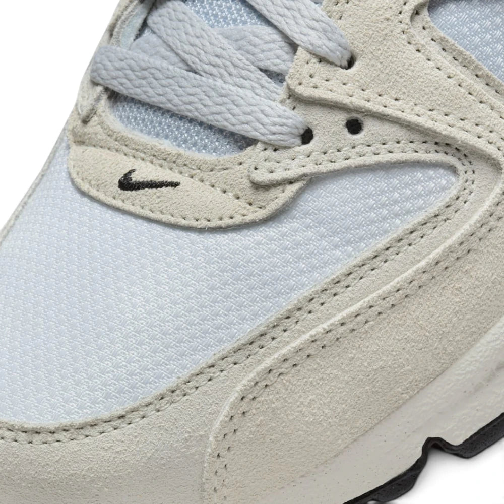 Details the micro-precision of the forefoot area, showing the textured off-white suede mudguard, double-stitched seams, light grey laces, and embroidered mini black Swoosh.