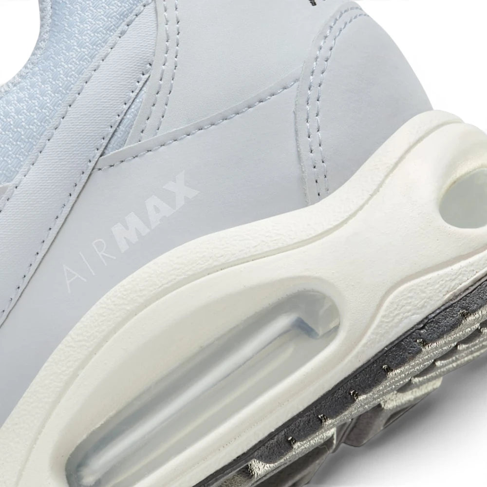 Highlights the "unreal" clean finish where the sculpted cream foam midsole meets the black Waffle rubber sole, showing the tonal debossed "AIR MAX" lettering above the clear Max Air window.