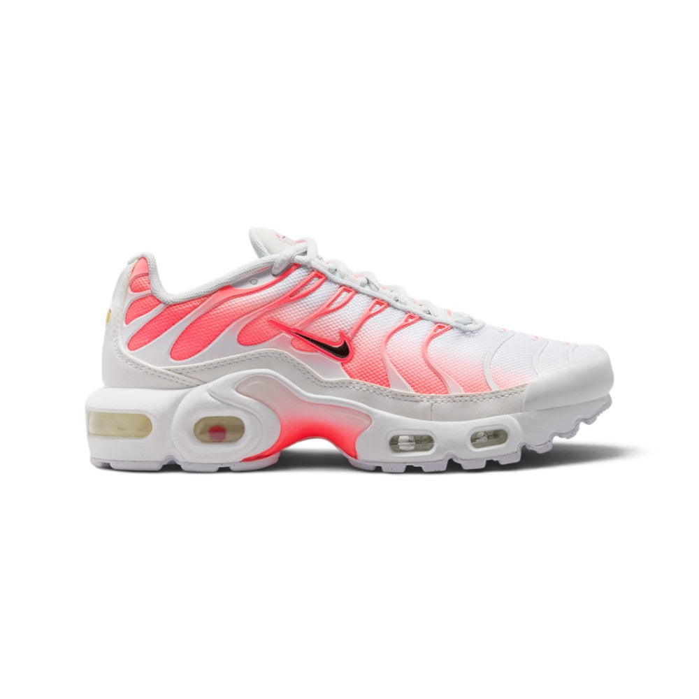 Highlights the lateral silhouette displaying the crisp white mesh upper, striking Hot Lava gradient TPU cage overlay, mini black Nike Swoosh with pink trim, glossy white toe bumper, sculpted white midsole, visible Max Air heel and forefoot windows, and bright lava whale's tail arch plate.