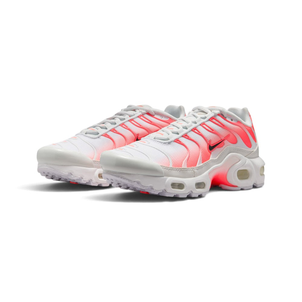 Emphasising the aggressive, curved stance of the junior trainers and the energetic glow of the Hot Lava cage lines against the clean white mesh upper.