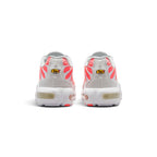 Focuses on the rear profile, displaying the structured off-white synthetic heel counters with radiant Hot Lava mesh underlays, yellow "Tn Air" emblems, and the solid base of the white foam midsole enclosing the Max Air chambers.