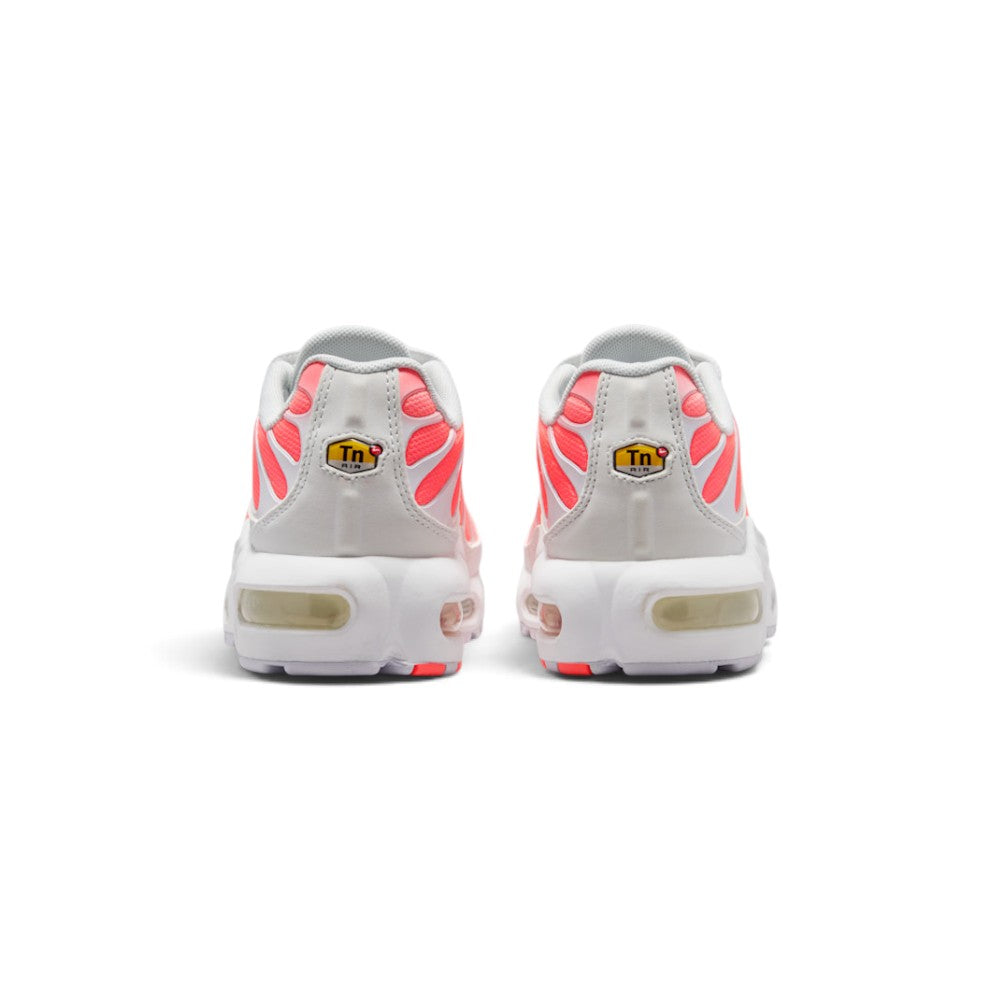 Focuses on the rear profile, displaying the structured off-white synthetic heel counters with radiant Hot Lava mesh underlays, yellow "Tn Air" emblems, and the solid base of the white foam midsole enclosing the Max Air chambers.