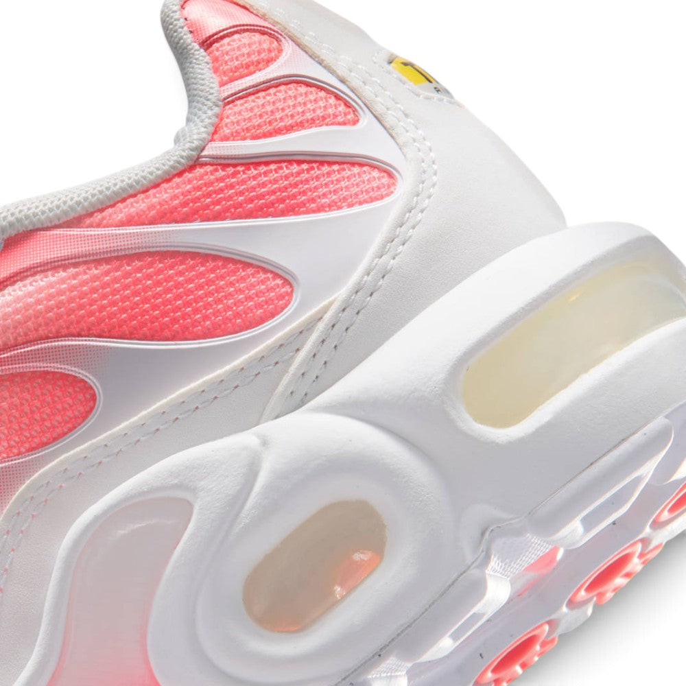 Highlights the "unreal" clean finish where the sculpted white foam midsole meets the transparent Max Air heel chamber, framed by the bright Hot Lava gradient arch plate and rubber outsole tread.