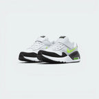 Emphasising the bold, forward-leaning athletic stance of the trainers and the professional harmony of the layered white, platinum, and neon volt paneling.