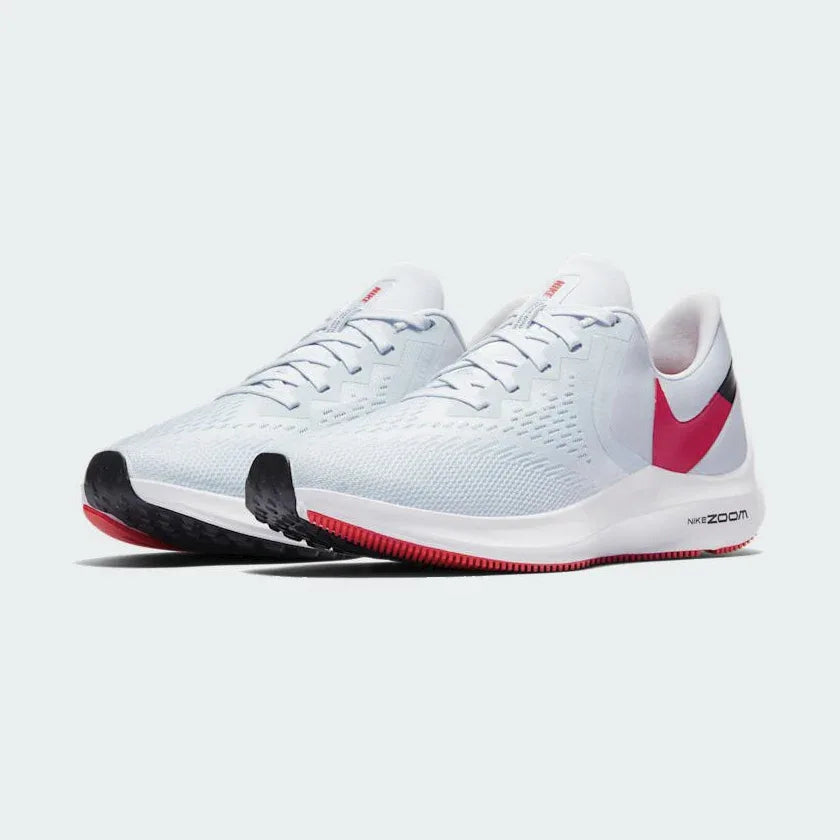 Angled view of two Nike Zoom Winflo 6 Women's blue running trainers, side by side, showcasing their versatile design and cushioned profile.