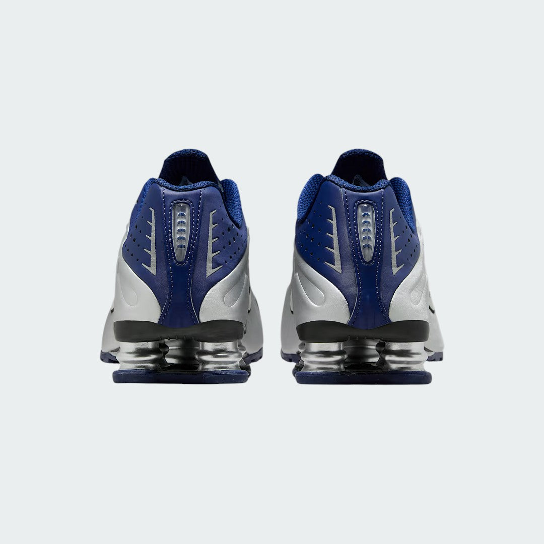 Rear view of the Nike Shox R4 women's trainers, focusing on the prominent Shox columns in the heel and the heel counter.
