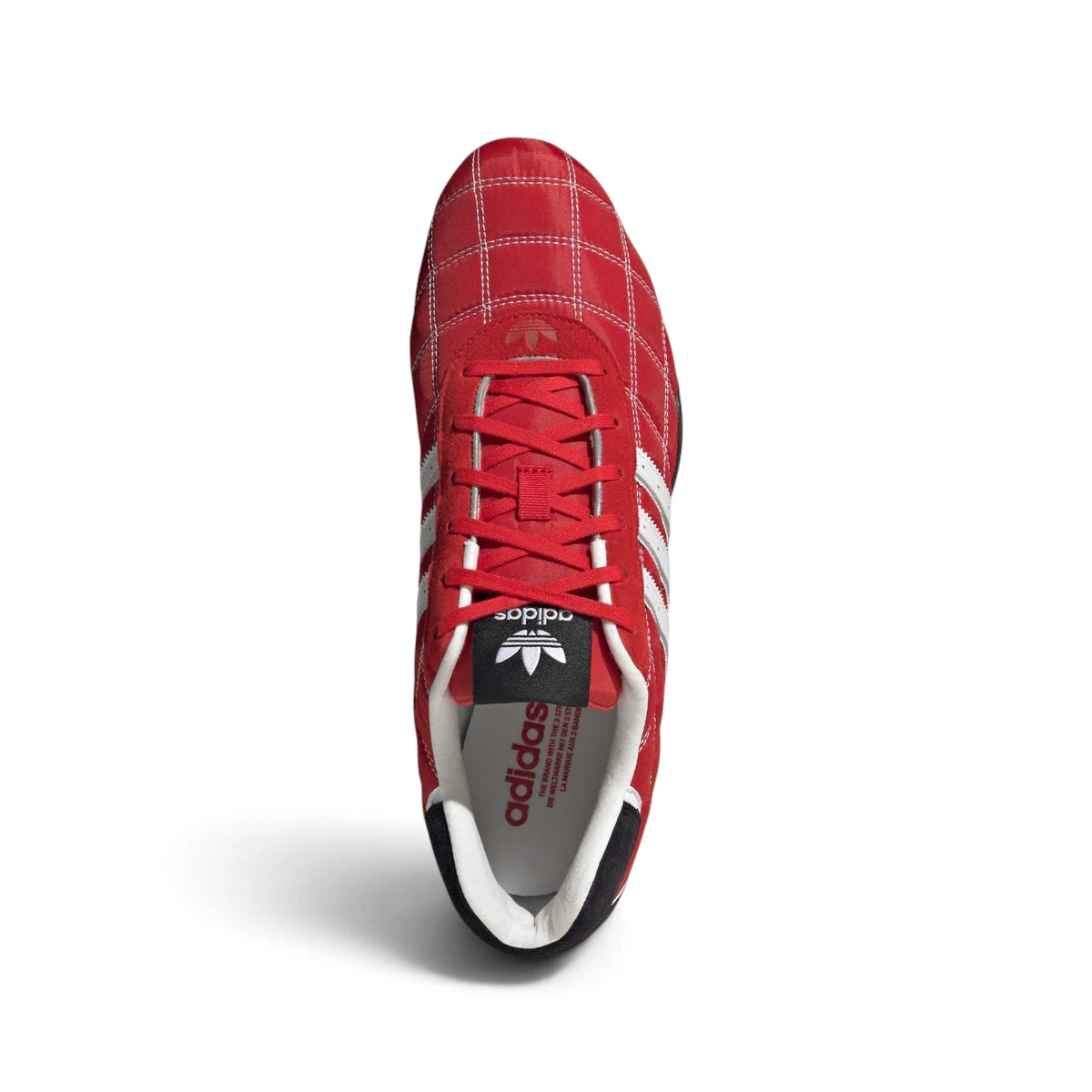 Overhead view looking down at the laced red driving shoes, displaying the red flat laces, slim tongue, and narrow collar opening.