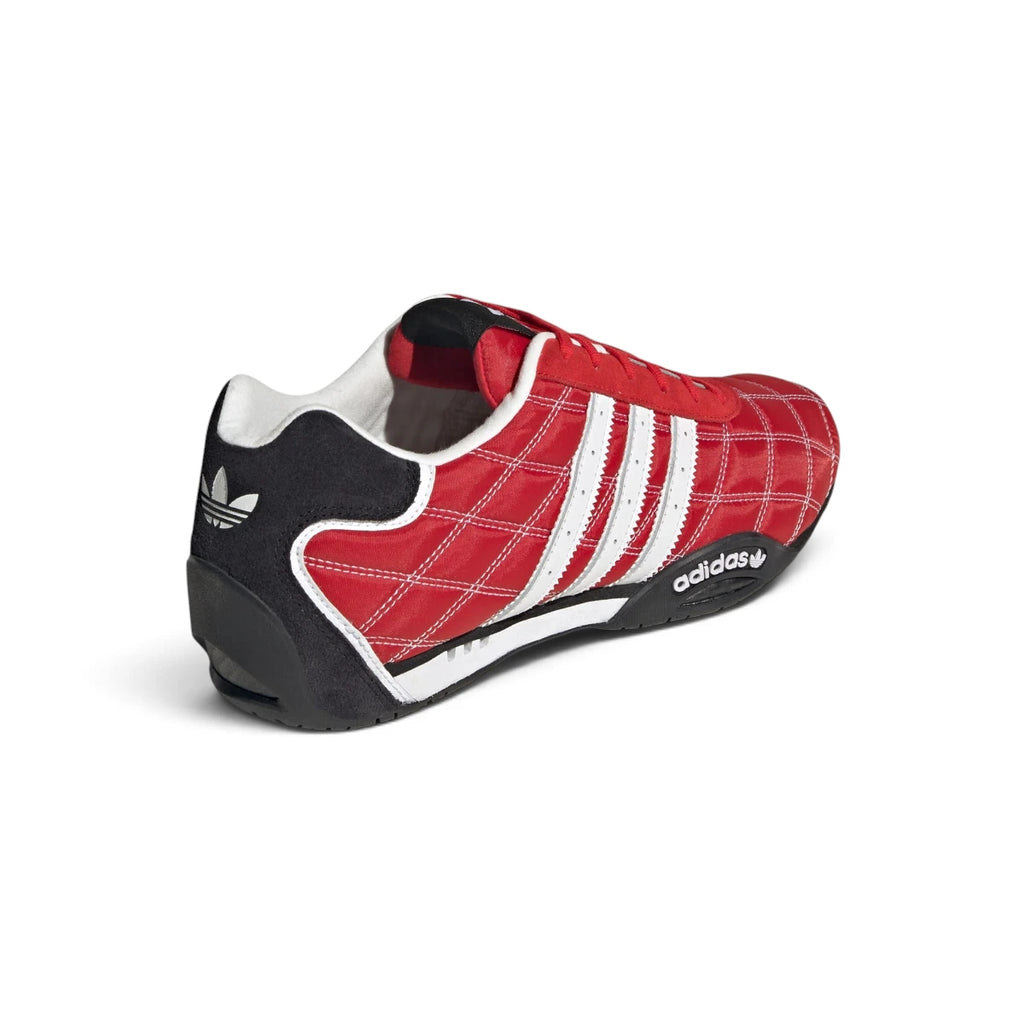 Rear-facing perspective focusing on the structured heel counter, reflective heel piping, and clean sole edge wrap.