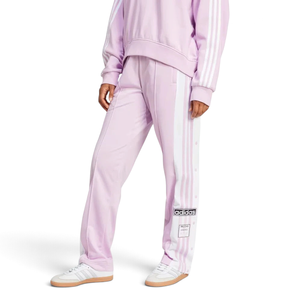 The Light Orchid Adibreak pants, highlighting the full-length white snap buttons and the contrast 3-Stripes against the soft purple base. Main image