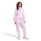 Woman wearing a pink tracksuit on a white background
