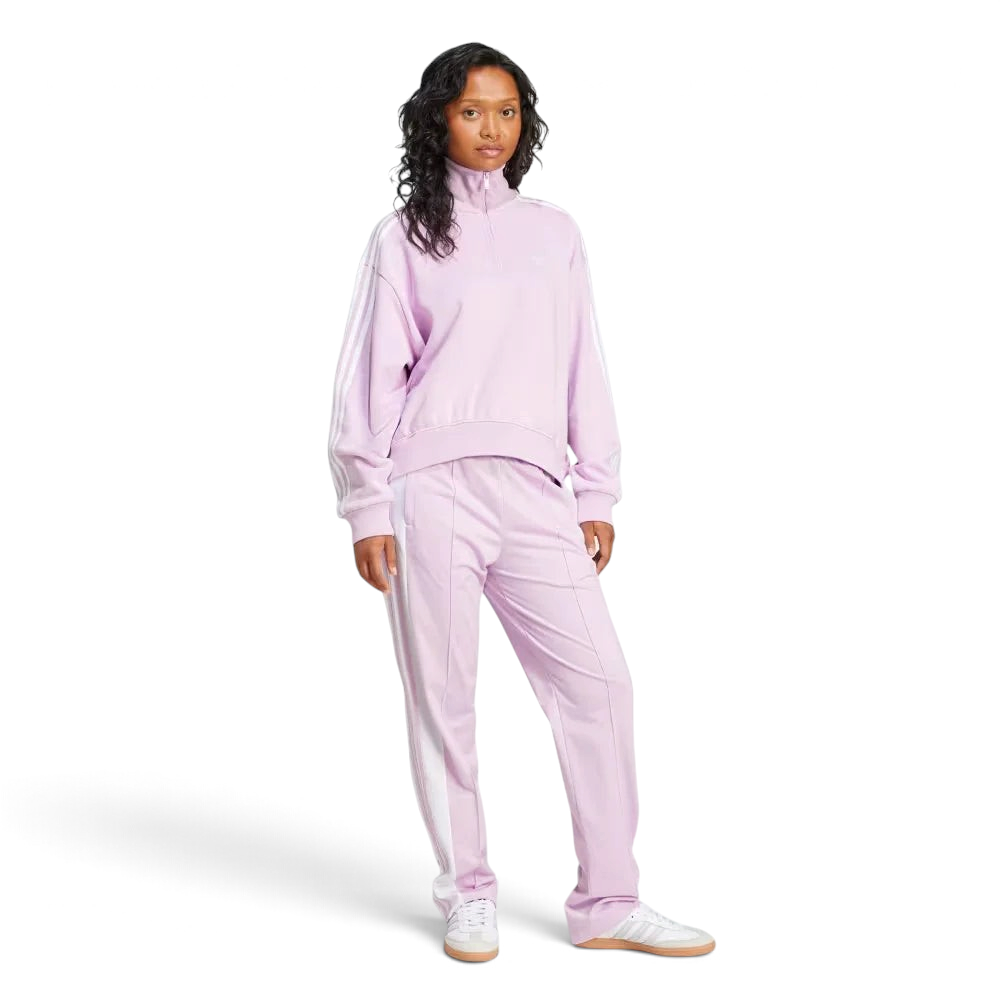 Woman wearing a pink tracksuit on a white background