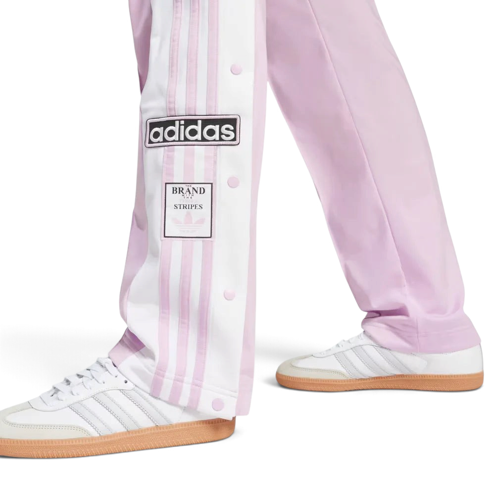 A close-up showing the bottom snap buttons opened to reveal a glimpse of the footwear underneath.