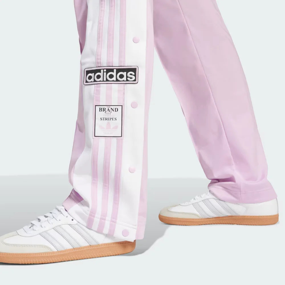 A close-up showing the bottom snap buttons opened to reveal a glimpse of the footwear underneath.