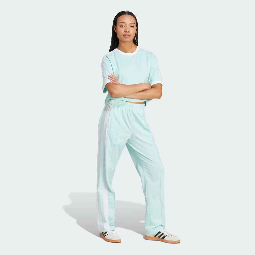 Person wearing a light blue tracksuit with white stripes on a white background