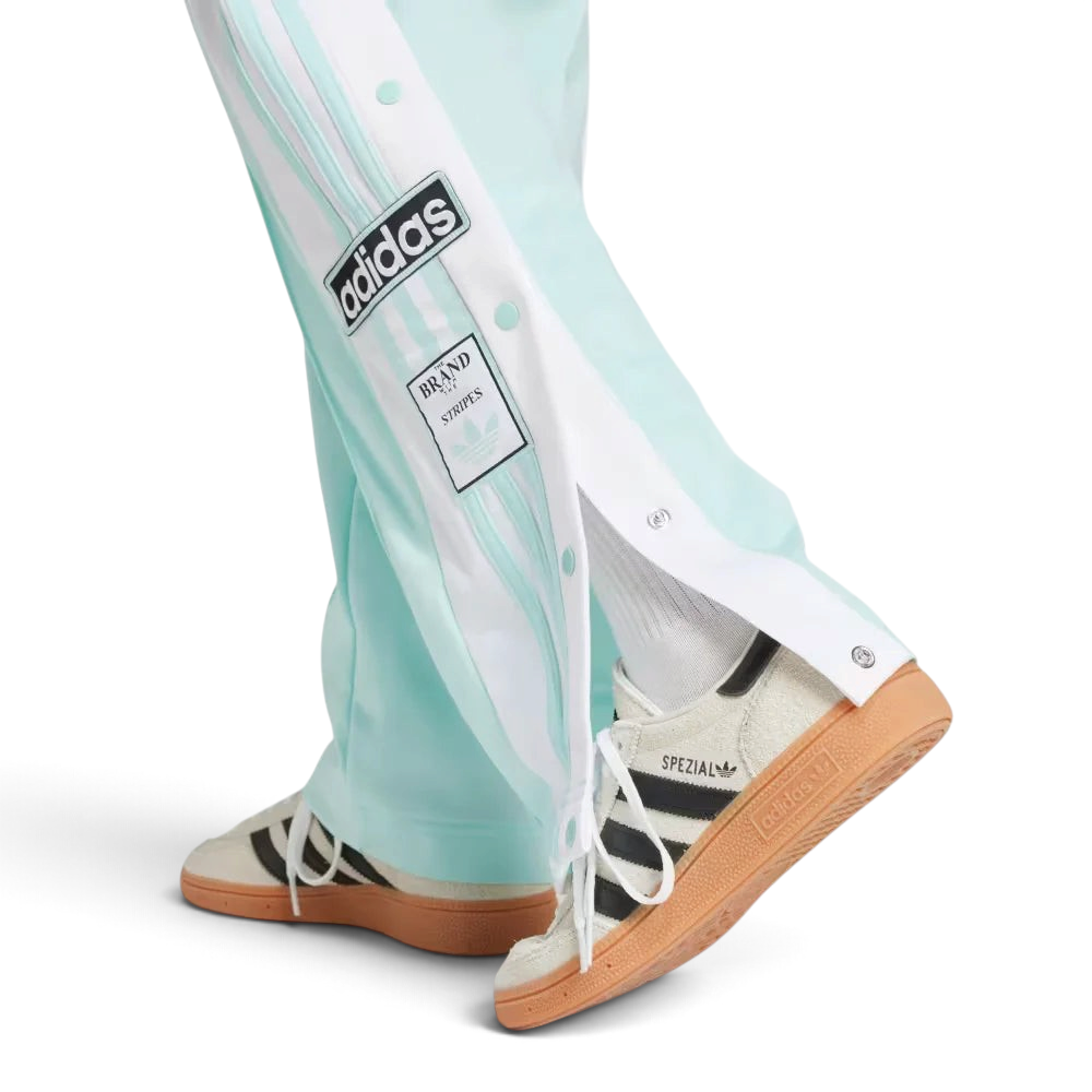 A close-up showing the bottom snap buttons opened to reveal a glimpse of the footwear underneath.
