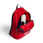 A red Adidas backpack with navy blue trim, shown open with its front pocket extended to reveal a white bottle and sunglasses inside. The Adidas trefoil logo is visible on the front pocket.